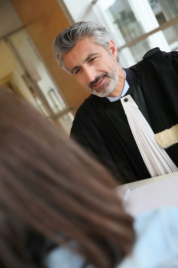 Lawyer meeting client in courthouse before trial